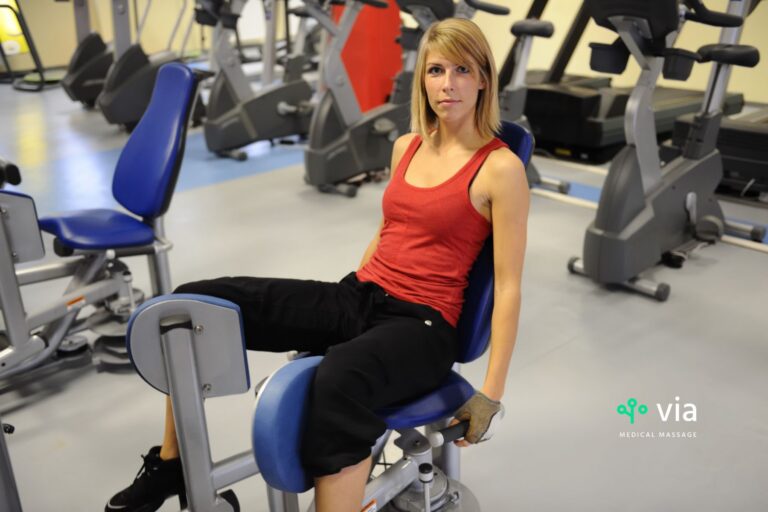 Woman at gym working on her adductor muscles